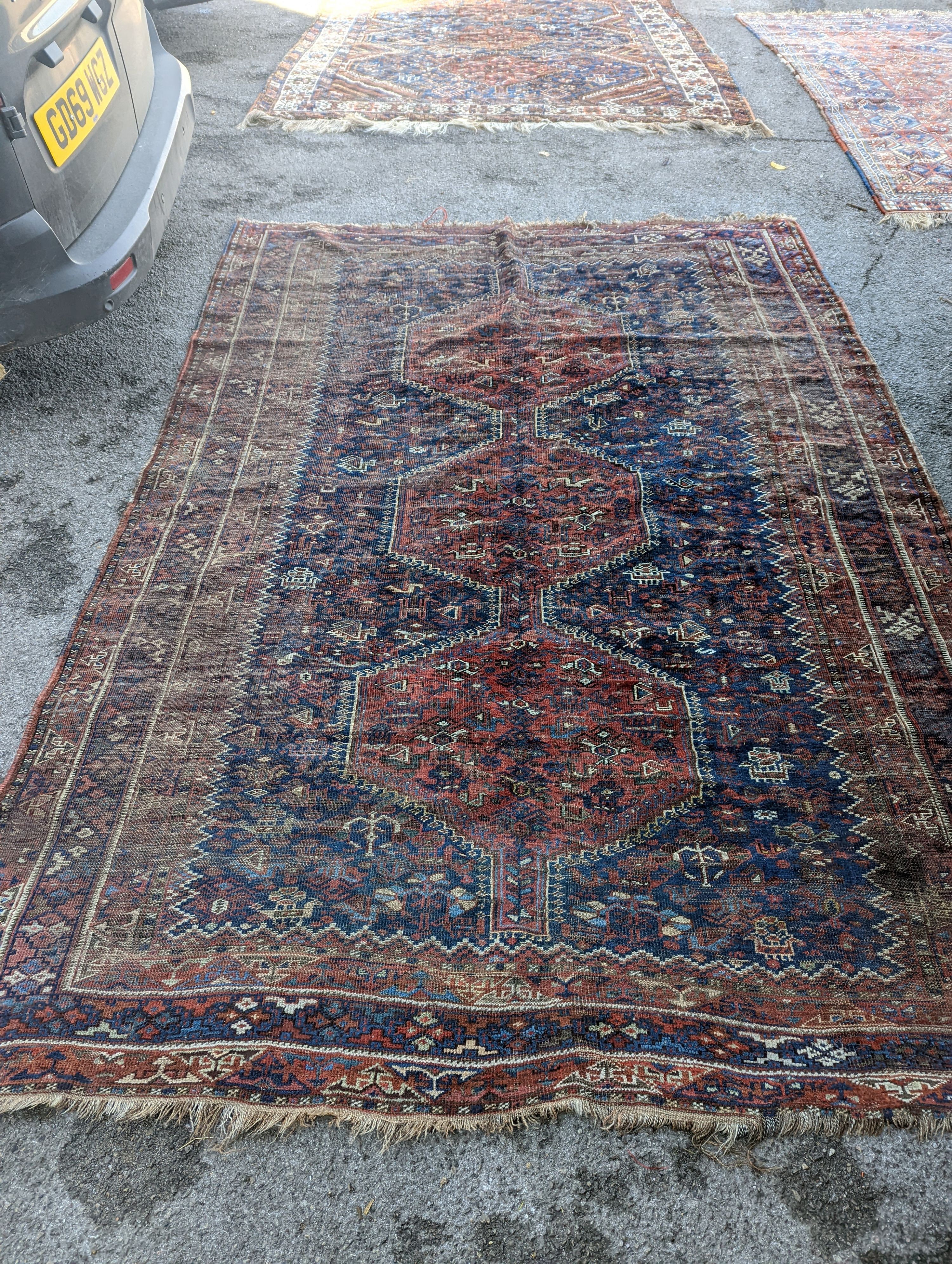 An antique Shirvan red ground carpet (worn), 295 x 207cm